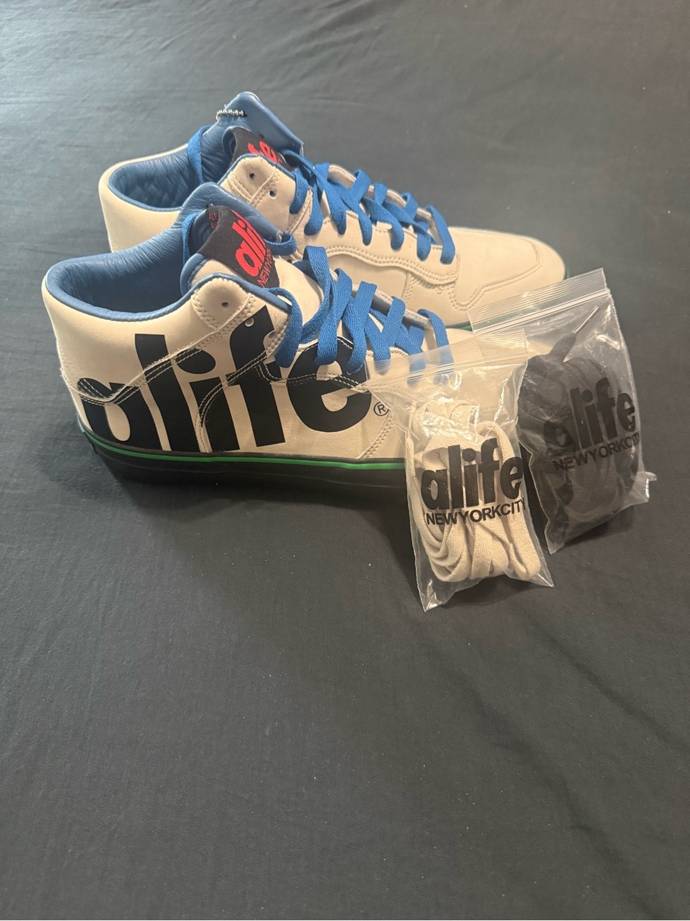 Alife White Sneakers with Blue Laces and Black Logo